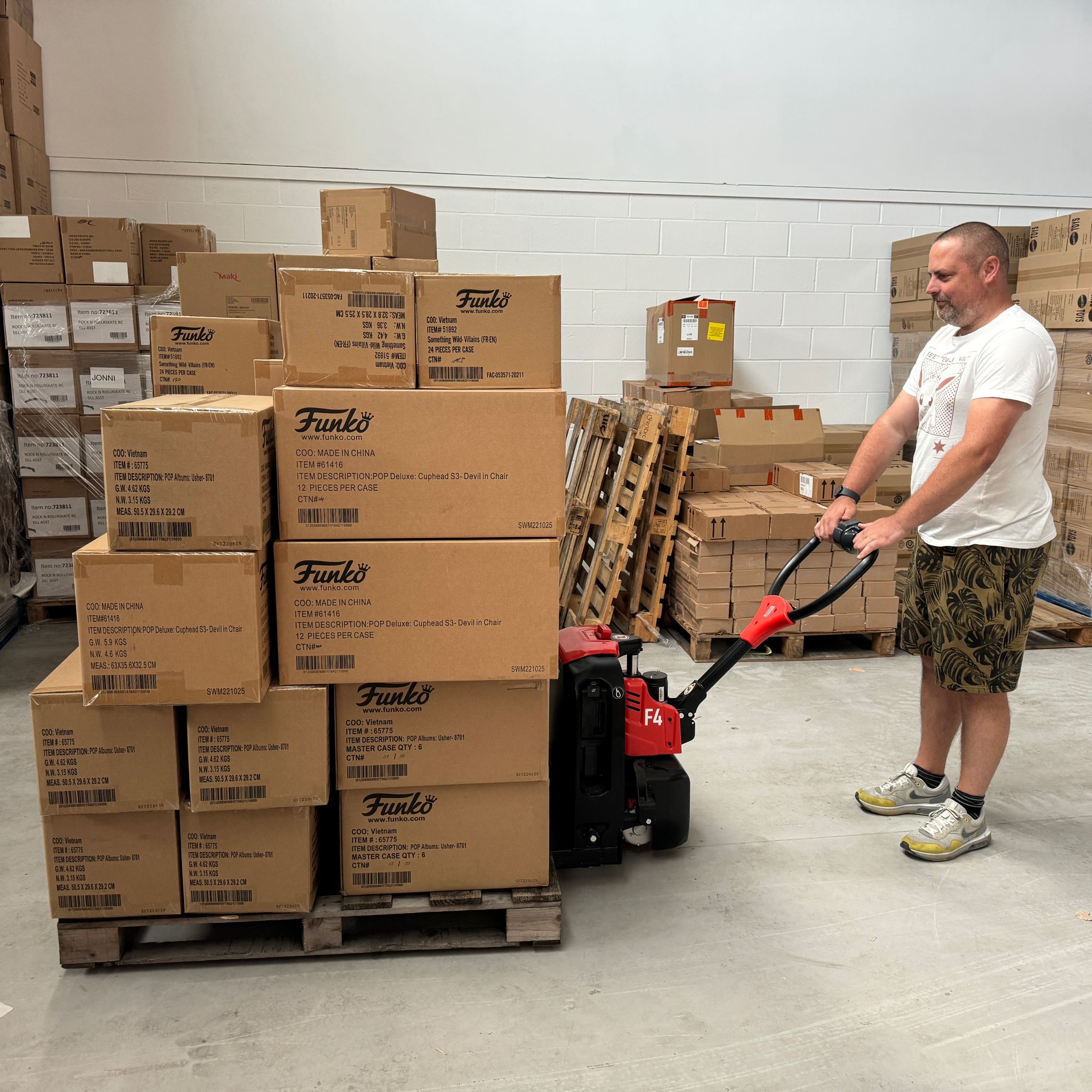 man pulling pallete in warehouse